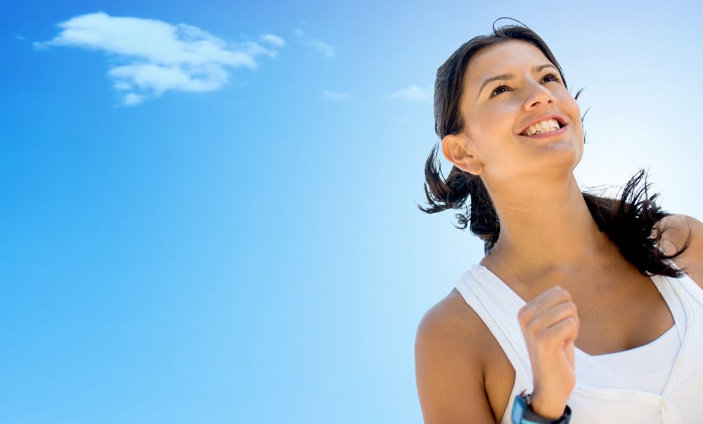 Woman running a marathon and looking very happy